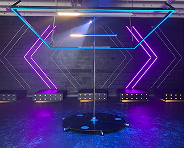 Lupit pole stage with neon purple and cyan stage lighting